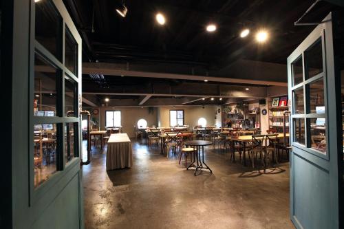 a restaurant with tables and chairs in a room at Tourism Inn in Yongkang