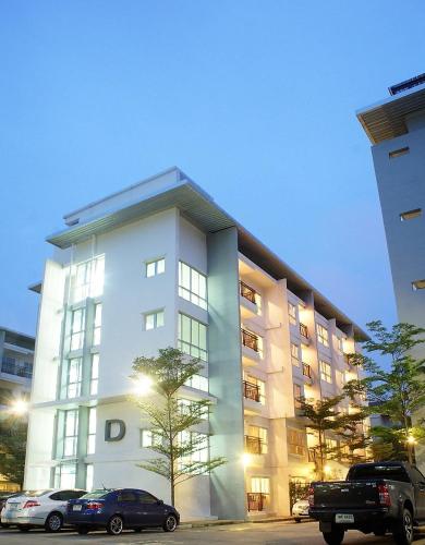 a white building with cars parked in front of it at The Cube Residence Government Complex Laksi in Lak Si