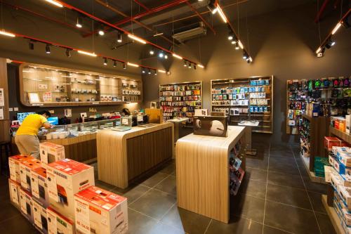 a store with a man standing at a counter in a store at Garden Sentral Hotel in Kuala Belait