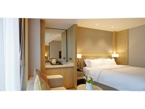 a hotel room with a bed and a mirror at Shenzhen FY Hotel in Shenzhen