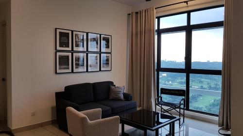 a living room with a couch and a large window at IOI Golf Suite in Putrajaya