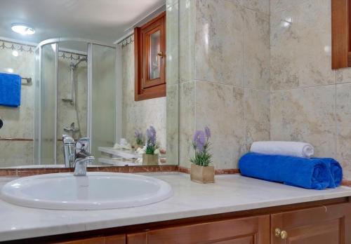a bathroom with a sink and a shower at Limassol Beachfront Holiday Villa in Limassol