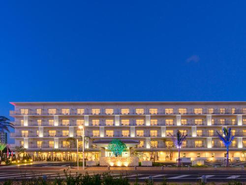 a large building with lights in front of it at La'gent Hotel Okinawa Chatan Hotel and Hostel in Chatan