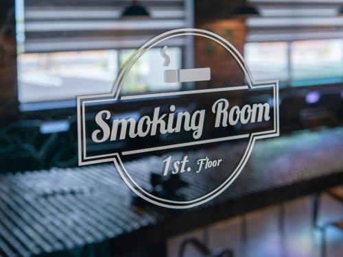 a sign that reads smoking room on a window at La'gent Hotel Okinawa Chatan Hotel and Hostel in Chatan