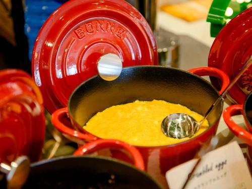 a pancake being prepared in a pot with a whisk at La'gent Hotel Okinawa Chatan Hotel and Hostel in Chatan