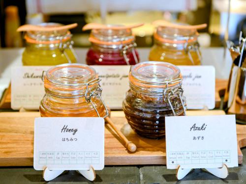 a display of jars of honey on a counter at La'gent Hotel Okinawa Chatan Hotel and Hostel in Chatan