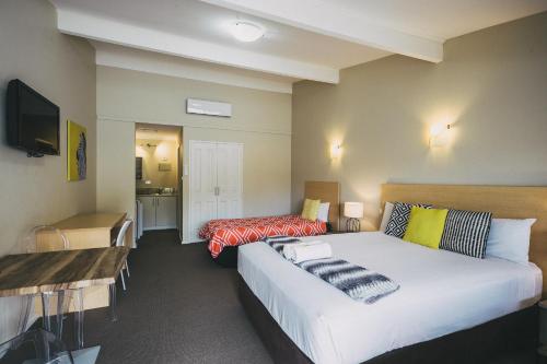 a hotel room with a bed and a desk at Six Degrees Motel in Albany