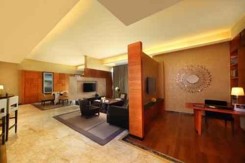 a living room with a couch and a table at Gokulam Grand Hotel & Spa Bangalore in Bengaluru