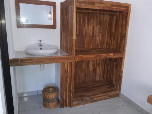 a bathroom with a sink and a mirror at Cape Rose in Gili Trawangan