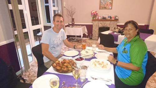 a man and woman sitting at a table with food at Richards Travel Lodge in Jamestown