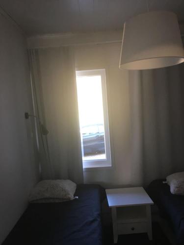a small room with a bed and a window at Paljakka Villas in Kotila