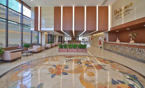 a lobby with a large rug in a building at Balcona Hotel Da Nang in Da Nang