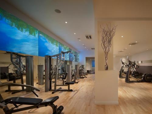 a gym with cardio equipment and a large aquarium at AKA Central Park in New York
