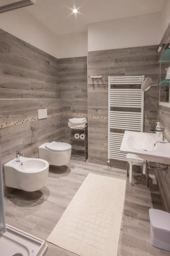 a bathroom with two sinks and two toilets at Ristorante Buasca in Cuorgnè