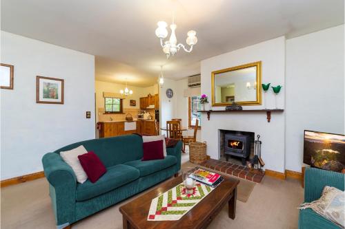 a living room with a couch and a table at Country Pleasures Bed and Breakfast in Angaston