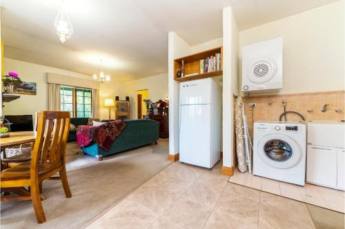 a kitchen and living room with a washer and dryer at Country Pleasures Bed and Breakfast in Angaston