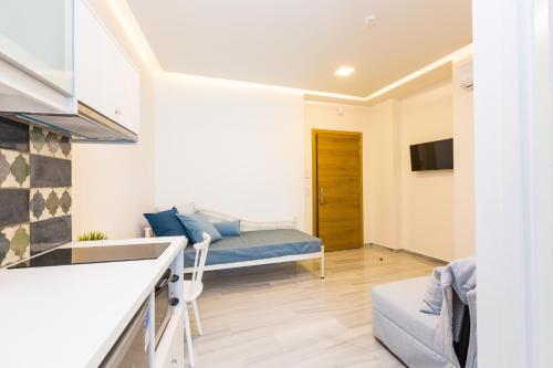 a kitchen and a living room with a couch at Meltemi Coast Suites in Rethymno Town