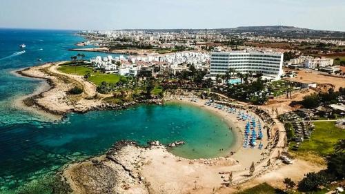 an aerial view of a beach and the ocean at Crystal Springs Beach Hotel in Protaras