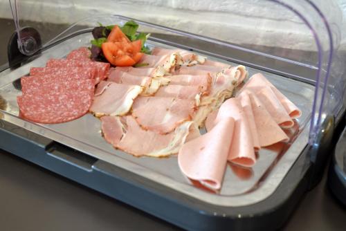 a tray of meat and other meats and vegetables at Hotel Schilberg in Slenaken