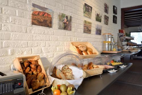a counter with baskets of bread and other foods at Hotel Schilberg in Slenaken
