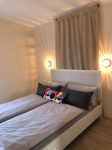 a bedroom with a bed with two lights on it at Villa Olyntha in Stomorska