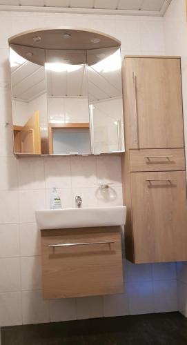 a bathroom with a sink and a mirror at Ferienwohnung Haus Kapellenblick in Winterberg