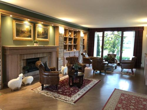 a living room with chairs and a fireplace at Agriturismo Il Boschetto in Ornago