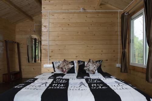 a bedroom with a large bed with wooden walls at Trippr Chikkamagaluru in Chikmagalūr