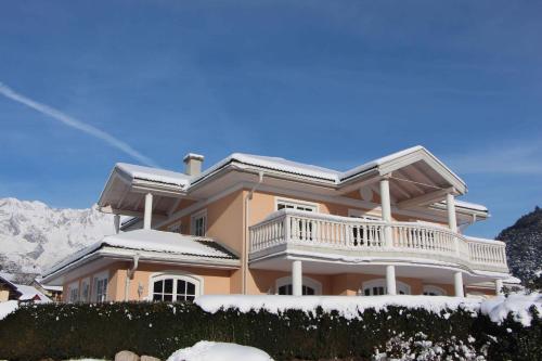 a large house with snow on the ground at Villa Wellness Homes in Mötz