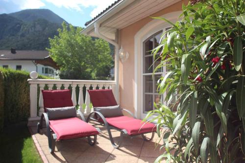 a pair of chairs on a patio with a window at Villa Wellness Homes in Mötz