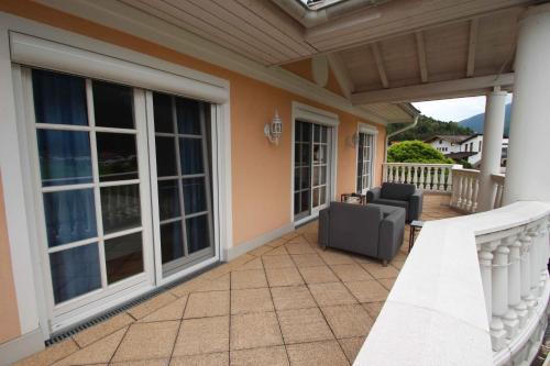 a porch with sliding glass doors and a couch at Villa Wellness Homes in Mötz
