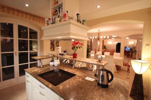 a kitchen with a counter top and a living room at Villa Wellness Homes in Mötz