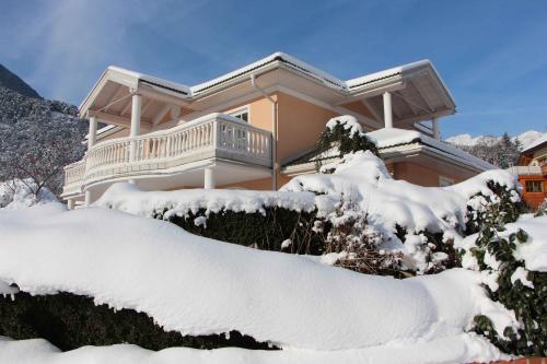 a house covered in snow in front of it at Villa Wellness Homes in Mötz