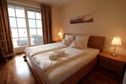 a bedroom with a large bed with two towels on it at Villa Wellness Homes in Mötz