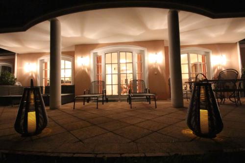 a group of chairs and tables in a building at night at Villa Wellness Homes in Mötz