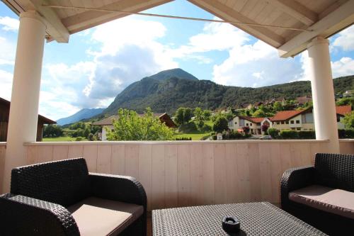 a porch with two chairs and a view of a mountain at Villa Wellness Homes in Mötz