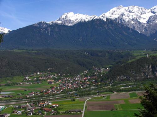 a small town in a valley with snow capped mountains at Villa Wellness Homes in Mötz