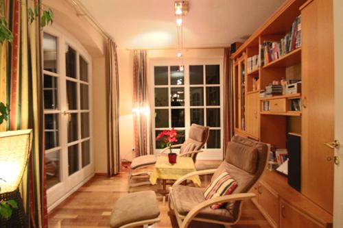 a living room with chairs and a table and a window at Villa Wellness Homes in Mötz