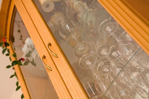 a glass window with a bunch of dishes in it at Villa Wellness Homes in Mötz