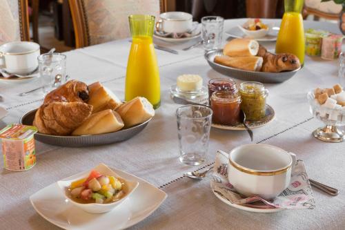 - une table avec des assiettes de pâtisseries et un bol de nourriture dans l'établissement Chez Marie et Jean François, à Dol-de-Bretagne