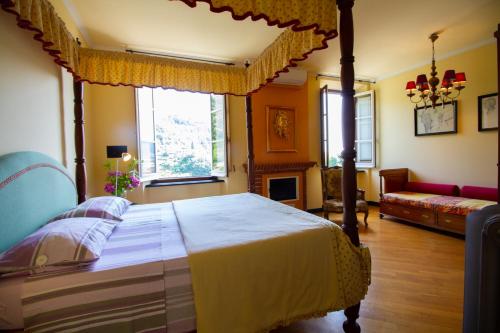 a bedroom with a canopy bed and a living room at Rivarola al Tempo Dei Castelli in Carasco