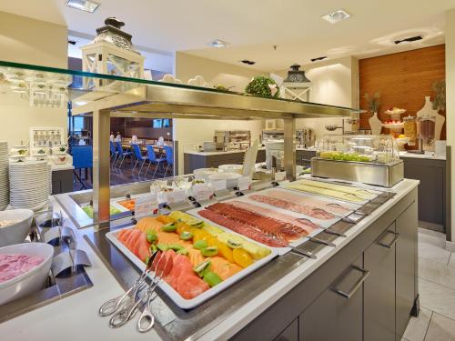a large buffet of food on a kitchen counter at Tivoli Hotel Innsbruck in Innsbruck