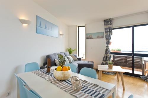 a living room with a couch and a table and chairs at Host Wise - Amazing Comfy Flat with Balcony in Matosinhos