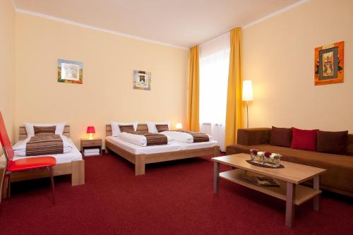 a living room with two beds and a couch at Apartment Abendstern in Berlin