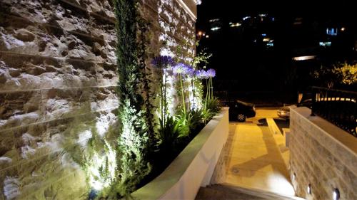 a retaining wall with lights on a building at Hotel Villa Gracia in Budva