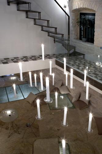 a chandelier with white candles in a room at Torri E Merli Boutique Hotel in Lákka