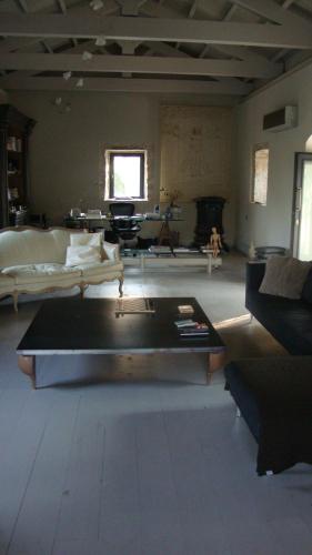 a large living room with a couch and a table at Torri E Merli Boutique Hotel in Lákka