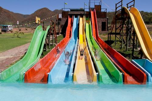 a group of slides in a water park at Wilgewandel Holiday Farm & Day Restaurant in Oudtshoorn