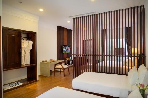 a hotel room with a bed and a desk at Sabara Angkor Resort & Spa in Siem Reap