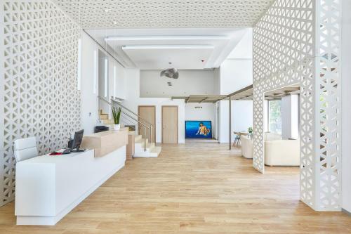an office with white walls and a hallway with a desk at Triton Boutique Hotel in Kos Town